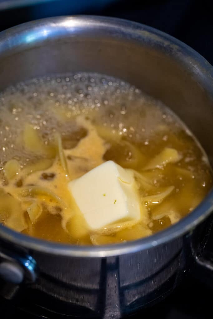 Adding butter to pot.