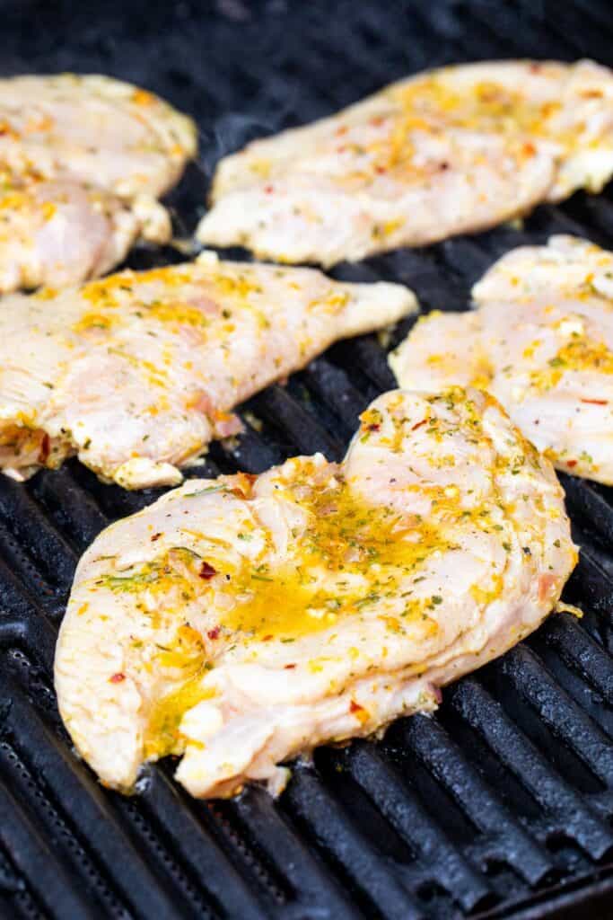 Grilling the citrus chicken on gas grill.