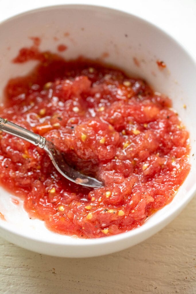 Seasoned tomato topping for ricotta toasts.