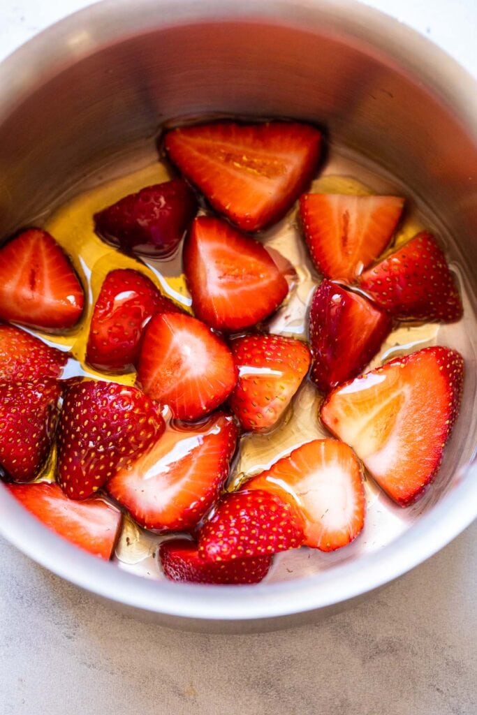 Cooking strawberries and honey.