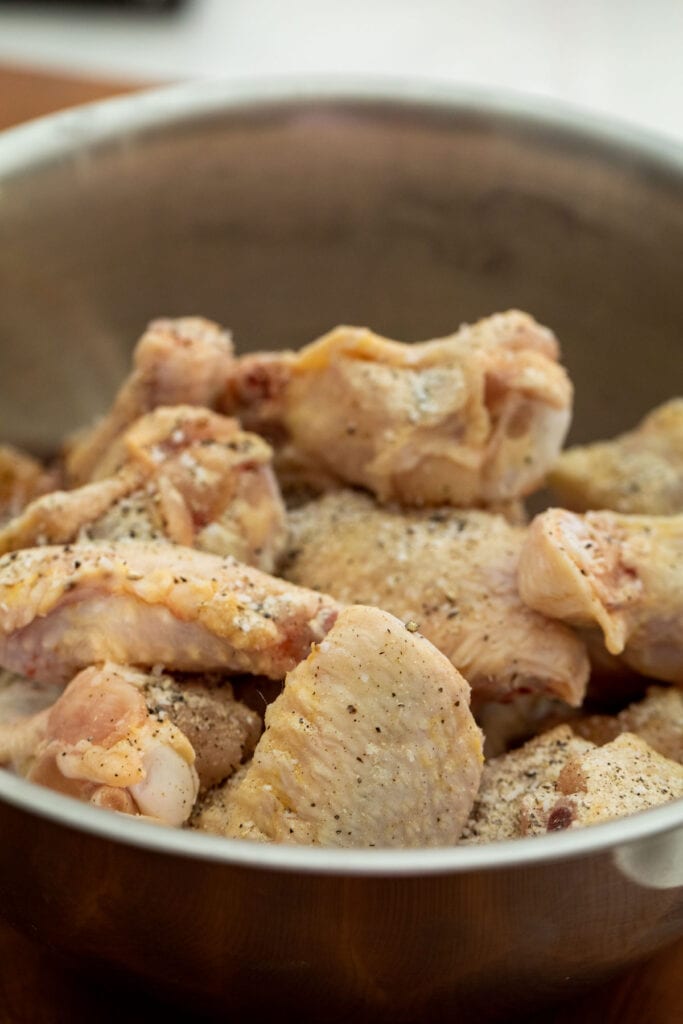 Prepping chicken wings for baking.