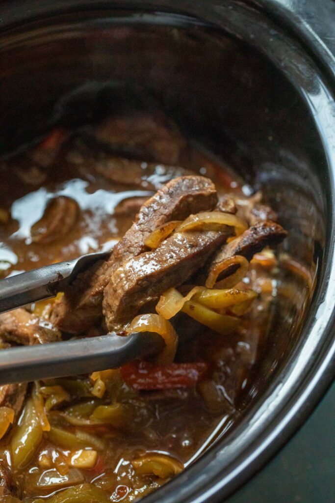 This slow cooker pepper steak is about as easy as dinner can get. Toss the ingredients in your cooker and come back to a delicious dinner! 