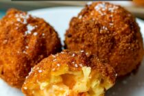 Homemade mac and cheese stuffed with pimento cheese and rolled into balls. Bread and fry the balls and these mac and cheese bites will be a stunner at any party! macheesmo.com #macandcheese #pimentocheese