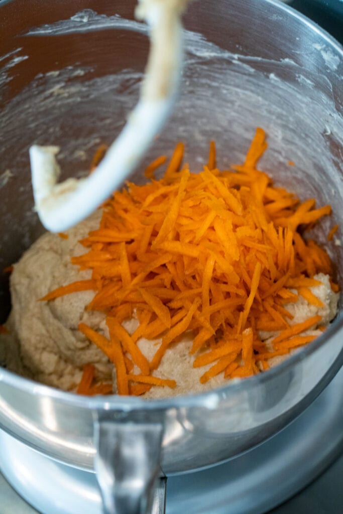 Adding carrots to dough.