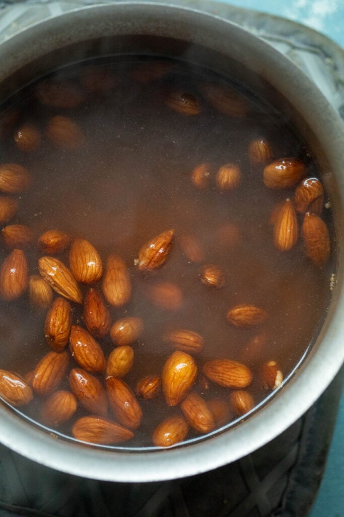 Boil the almonds before peeling them. 