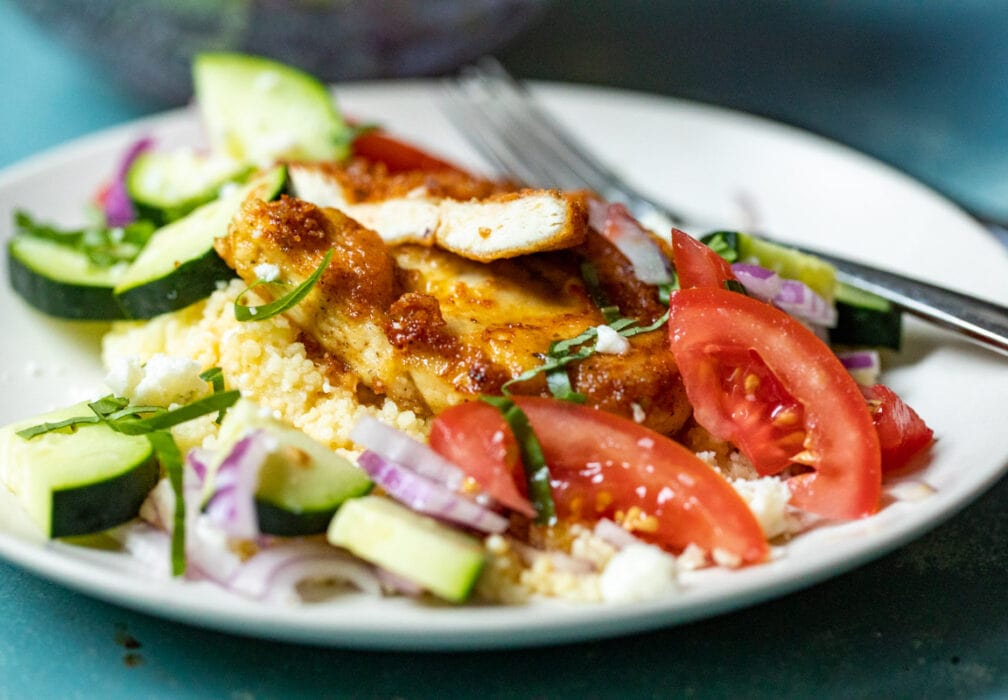 Chicken Couscous with salad on a plate.
