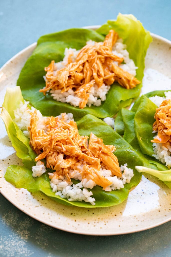 Making the lettuce wraps with rice and buffalo chicken. 
