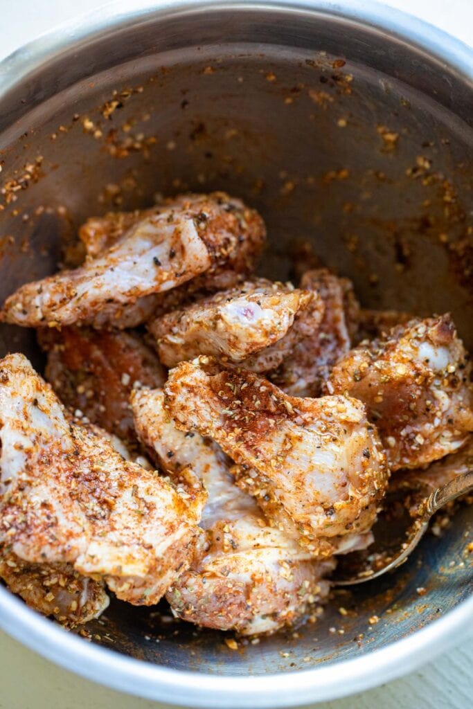 Seasoning chicken wings.