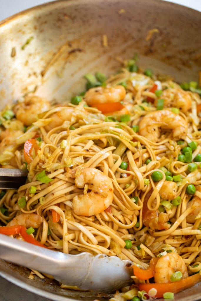 Shrimp lo mein done in a wok.